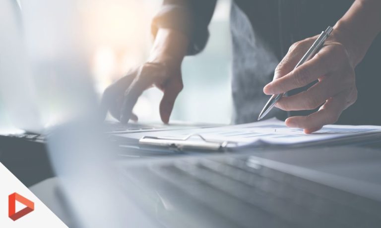 Mains signant un document sur un bureau